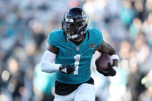 Travis Etienne Jr. #1 of the Jacksonville Jaguars runs the ball during the fourth quarter against the Carolina Panthers at EverBank Stadium on December 31, 2023 in Jacksonville, Florida.