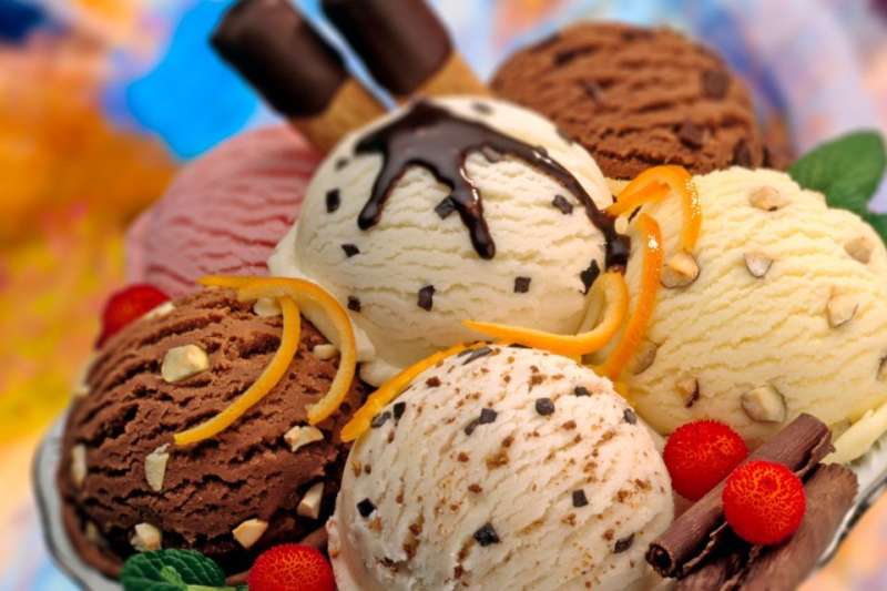 Six sundae flavors in a large bowl with sprinkles and indulgent dessert toppings.
