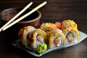 A plate of sushi and chopsticks.